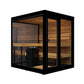 Black framed outdoor sauna with glass doors and windows, cedar wood interior with benches and black heater stove on white bac