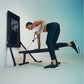 Person using black Tonal 2 Smart Home Gym with mounted display screen, performing strength training exercise with cable attac