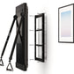 Black Tonal 2 smart home gym system showing wall-mounted display unit with tripod stand, mounting bracket, and installed fram