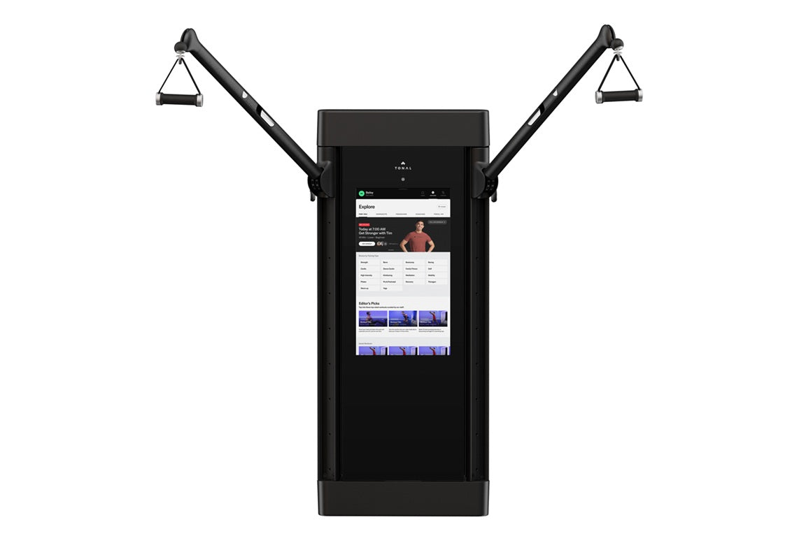 Black Tonal 2 smart home gym with dual adjustable arms and digital display screen showing workout interface on white backgrou