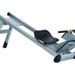 Total Gym Row Trainer with gray steel frame, black perforated seat, and wheels on white background