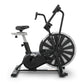 Black and silver stationary air bike with large fan wheel, dual handlebars, padded seat, and digital display on white backgro