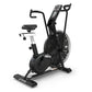 Black TRUE ADX exercise air bike with large fan wheel, digital display console, curved handlebars, black cushioned seat, and 