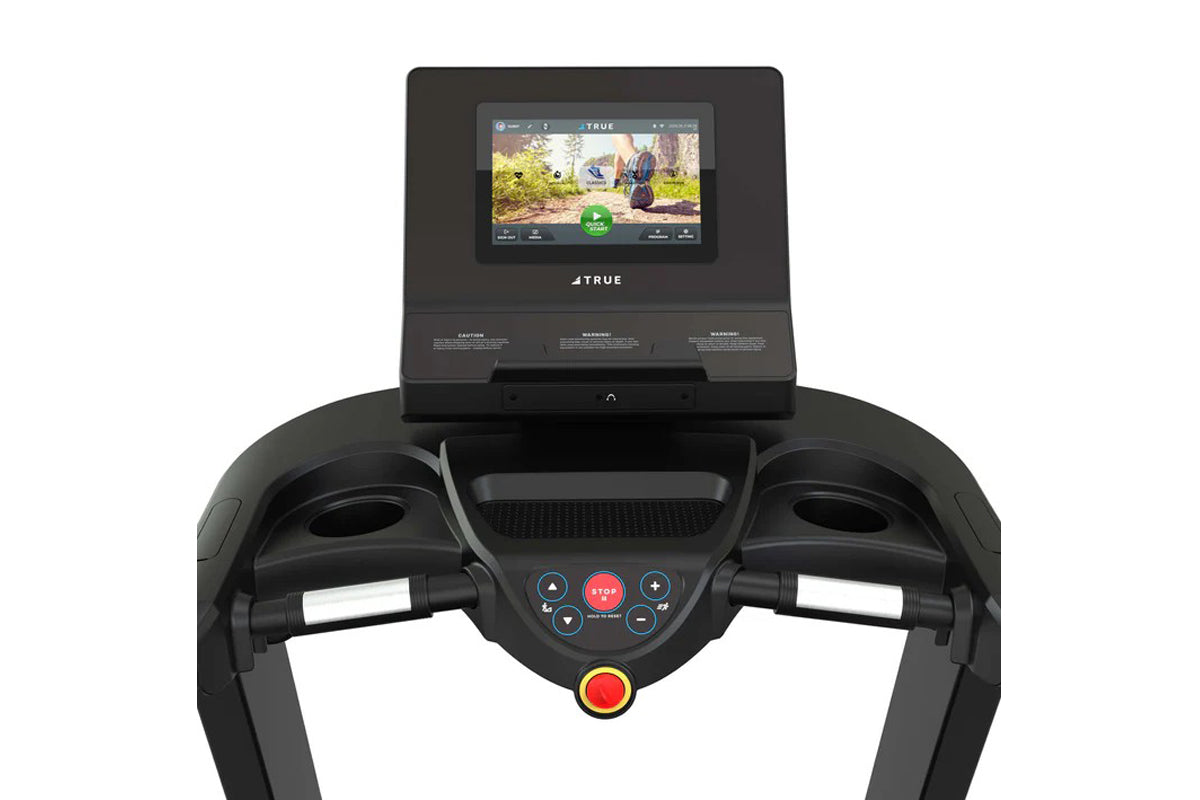 Black TRUE Performance 8000 treadmill with touchscreen display showing workout video, dual handles, and control buttons on wh