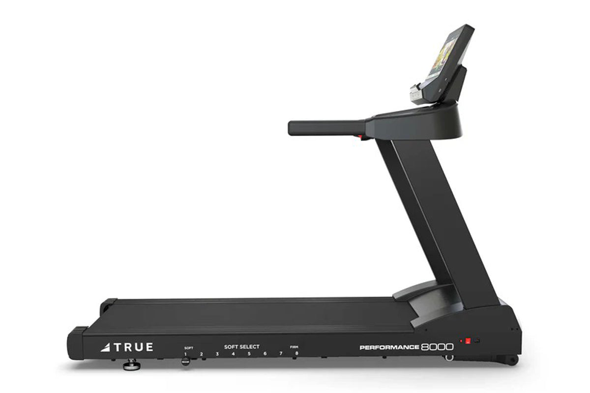 TRUE Performance 8000 black treadmill with digital display, soft select controls, and cushioned running deck on white backgro
