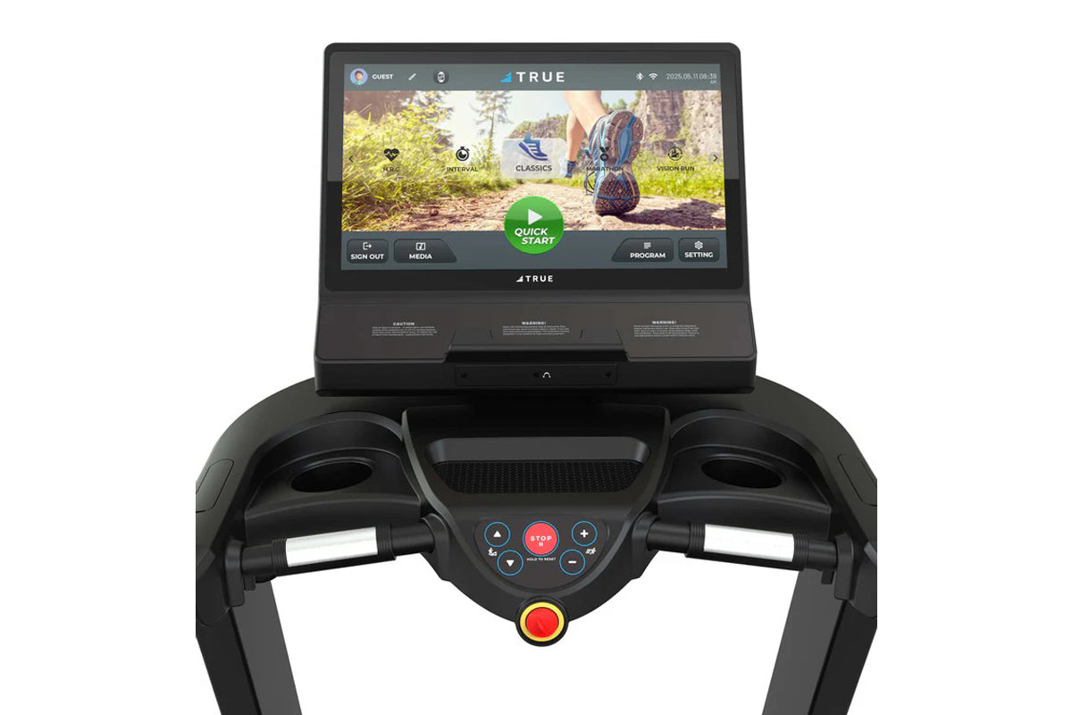 Black TRUE treadmill with display screen showing hiking trail interface and control console with directional buttons and red 