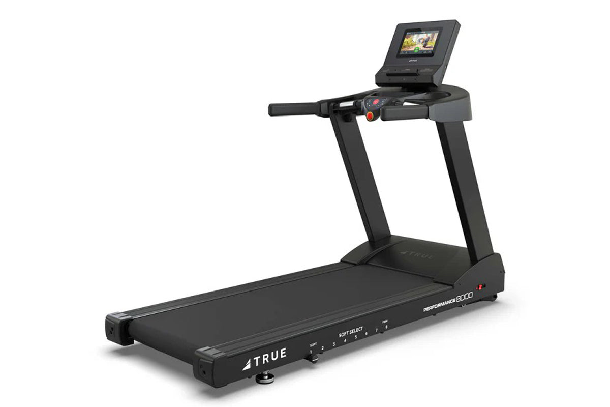 Black True Performance 8000 treadmill with digital touchscreen console, control panel, and cushioned running deck on white ba