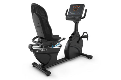 Black recumbent exercise bike with mesh backrest, digital display console, and foot pedals, shown on white background