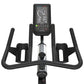 Black stationary spin bike with curved handlebar grips, digital display console showing recovery and heart rate metrics, on w