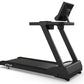 Black commercial treadmill with digital display monitor, wide running deck, and dual support handles on white background