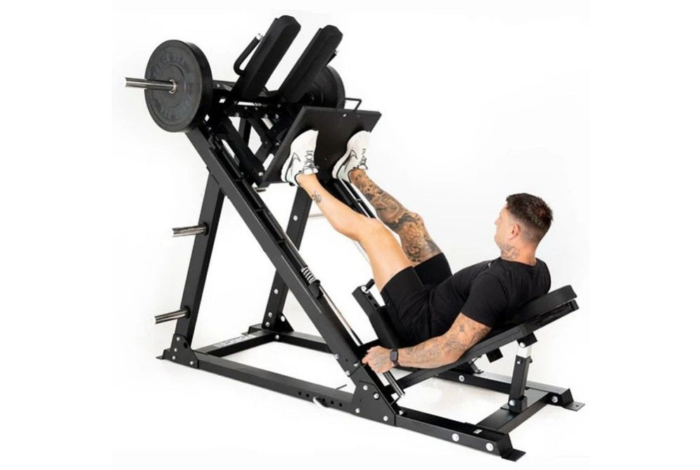 Black leg press and hack squat machine with weight plate, demonstrating use by male model in black shirt on white background