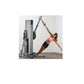 Woman in pink sports bra and black shorts using silver and gray functional trainer machine with dual cable stacks in plank po