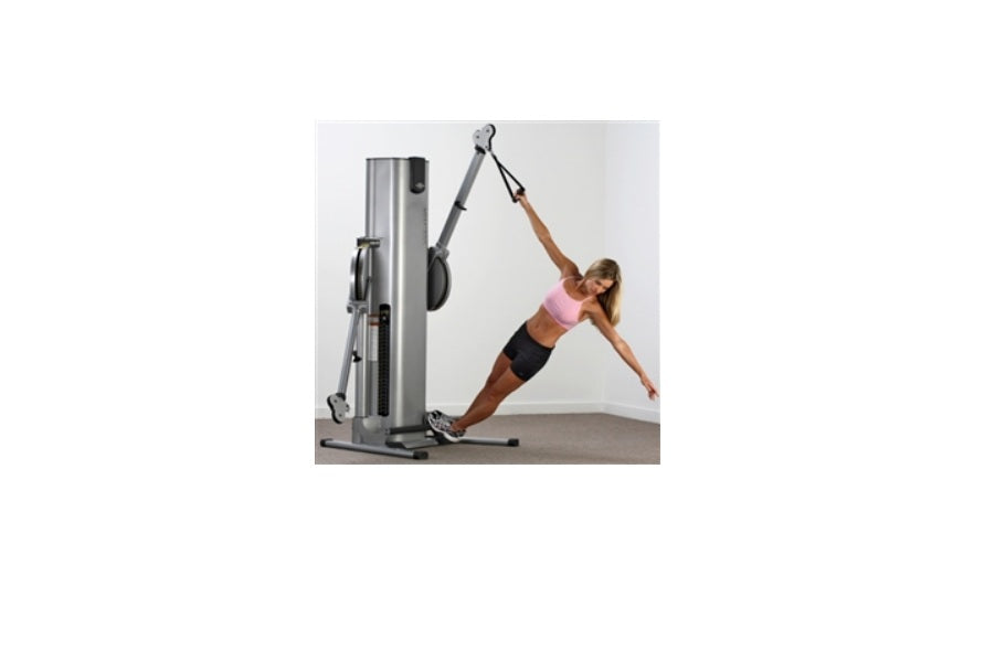 Woman in pink sports bra and black shorts using silver and gray functional trainer machine with dual cable stacks in plank po