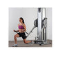 Woman using silver and black Vectra Fitness functional trainer with dual cable stacks, wearing purple sports bra and black sh