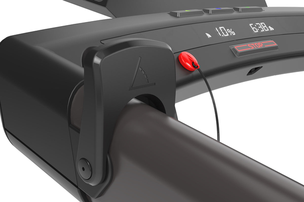 Black KICKR RUN smart treadmill with red stop button and digital display showing battery and time, angled view on white backg