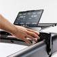 Hand operating black KICKR RUN smart treadmill console displaying workout metrics and digital display screen