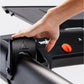 Hand adjusting black control knob on KICKR RUN smart treadmill with orange button visible