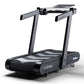 Wahoo KICKR RUN smart treadmill with gray frame, black and gray belt, dual handles, and digital display on white background