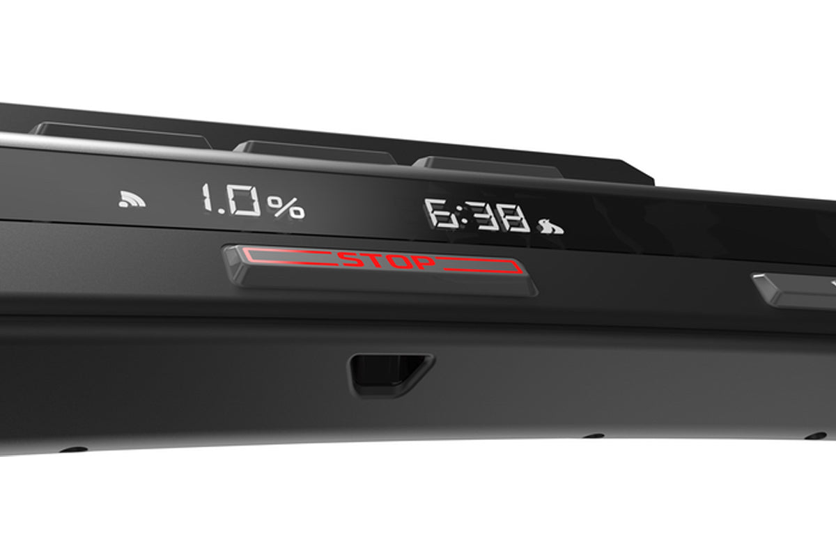 Black treadmill console displaying battery level, time, and red stop button on white background