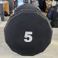 Black 5-pound urethane dumbbell with white number marking, 12-sided shape, on white surface