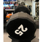 Black 50-pound 12-sided urethane dumbbell with white weight marking, in gym setting
