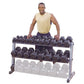 Man wearing cream tank top and navy shorts standing behind three-tier dumbbell rack with black hexagon dumbbells on upper two