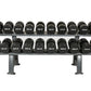 Two-tier metal dumbbell rack holding twenty black urethane dumbbells with white weight labels, on white background
