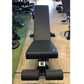 Black flat incline decline weightlifting bench with padded seat and back support, viewed from above in gym setting