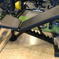 Black and blue adjustable weight bench with padded seat and backrest, sturdy metal frame, displayed in gym setting