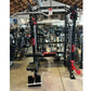 Warrior cable crossover power rack with dual black uprights, red accents, adjustable pulleys, lat pulldown attachment, and we