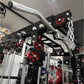 Warrior 3.0 cable crossover pulley power rack with red weight plates and gray pull-down bar on black frame