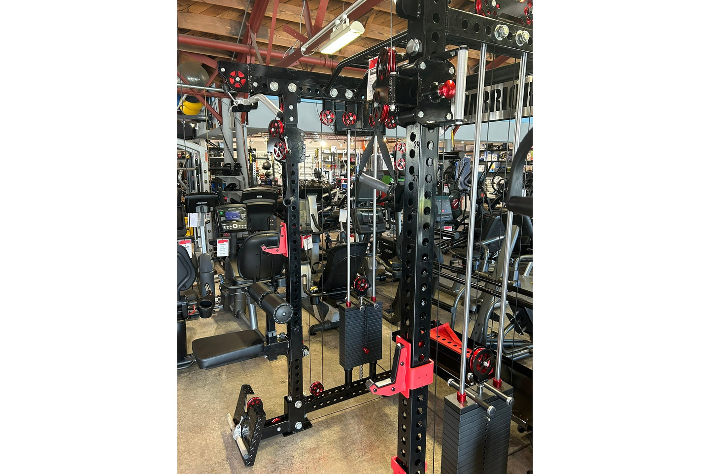 Warrior 3.0 Cable Crossover Power Rack with black steel frame, red pulleys and handles, lat pulldown attachment, displayed in