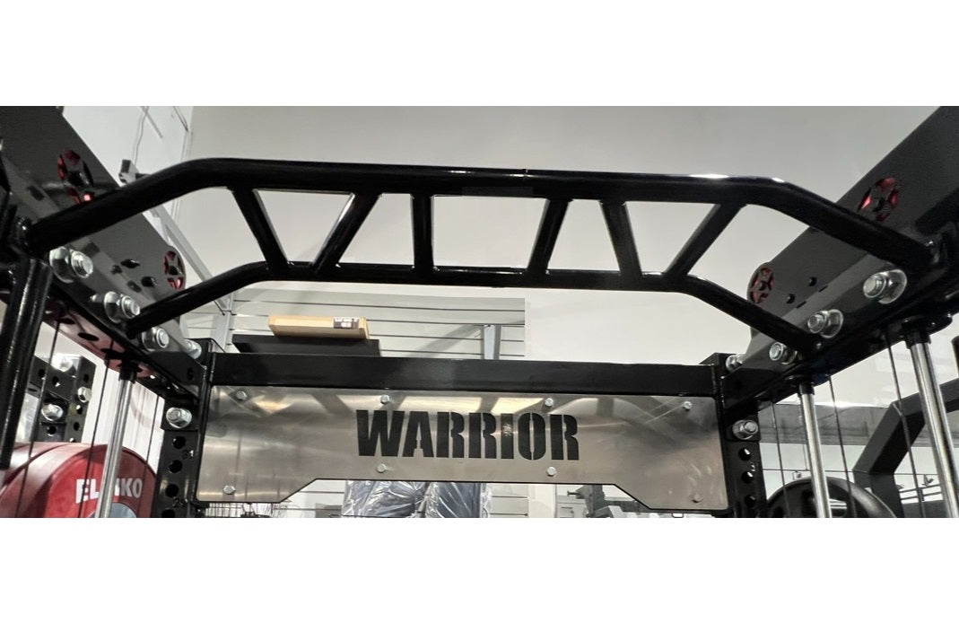 Black steel cable crossover power rack with integrated lat pulldown station and stainless steel nameplate, displayed in gym s