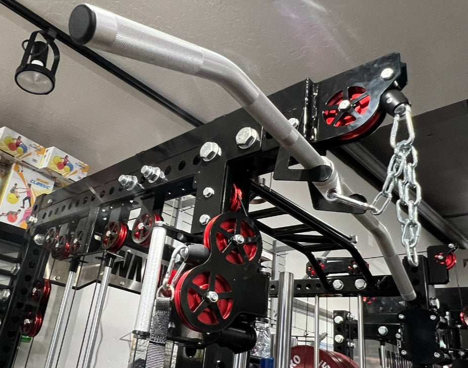 Black metal cable machine with white and gray handles, red pulleys, and silver chain attachment