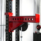 Red and black cable crossover pulley attachment mounted on black power rack with perforated uprights and numbered markings