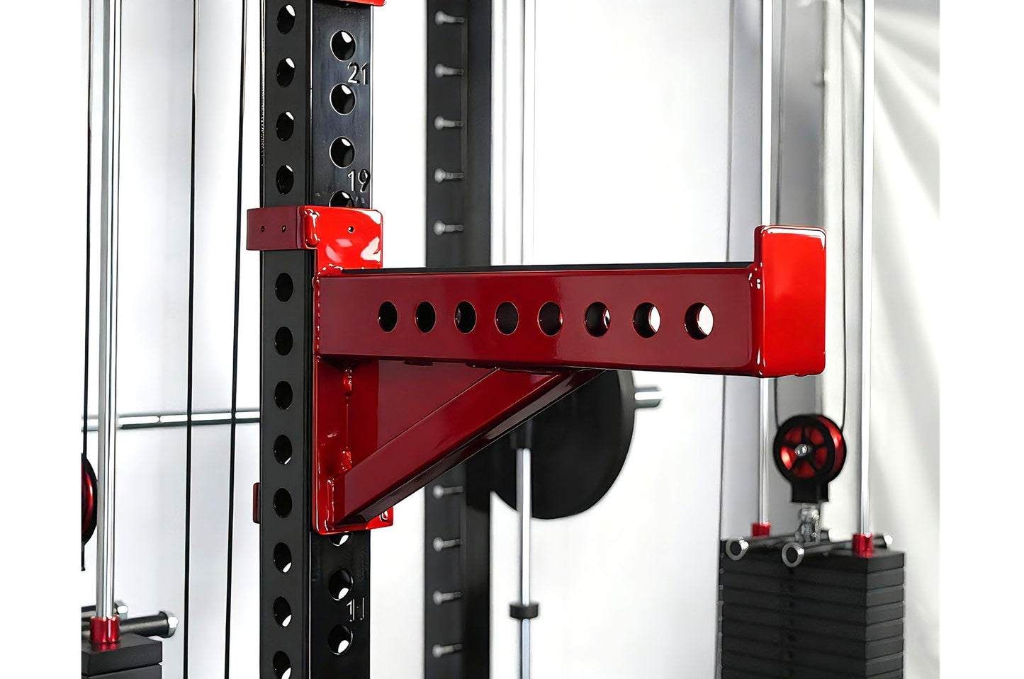Red and black cable crossover pulley attachment mounted on black perforated power rack frame with white uprights, shown from 