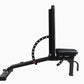 Black adjustable weight bench with padded seat and backrest, leg extension attachment, and red adjustment bolts on white back