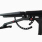 Black adjustable weight bench with padded seat and backrest, red adjustment handles, and leg extension attachment on white ba