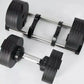 Black adjustable dumbbells with textured grip plates and chrome handles, shown as pair on white background