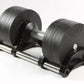 Pair of black adjustable dumbbells with segmented weight plates and metal handle on white background