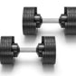 Pair of black rubber-coated adjustable dumbbells with grooved weight plates and gray metal handles on white background