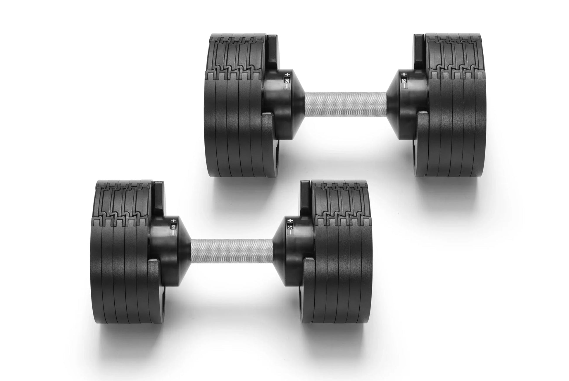 Pair of black rubber-coated adjustable dumbbells with grooved weight plates and gray metal handles on white background