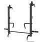 Black steel power rack with dual vertical posts, adjustable safety bars, cable attachments, and functional trainer arms on wh