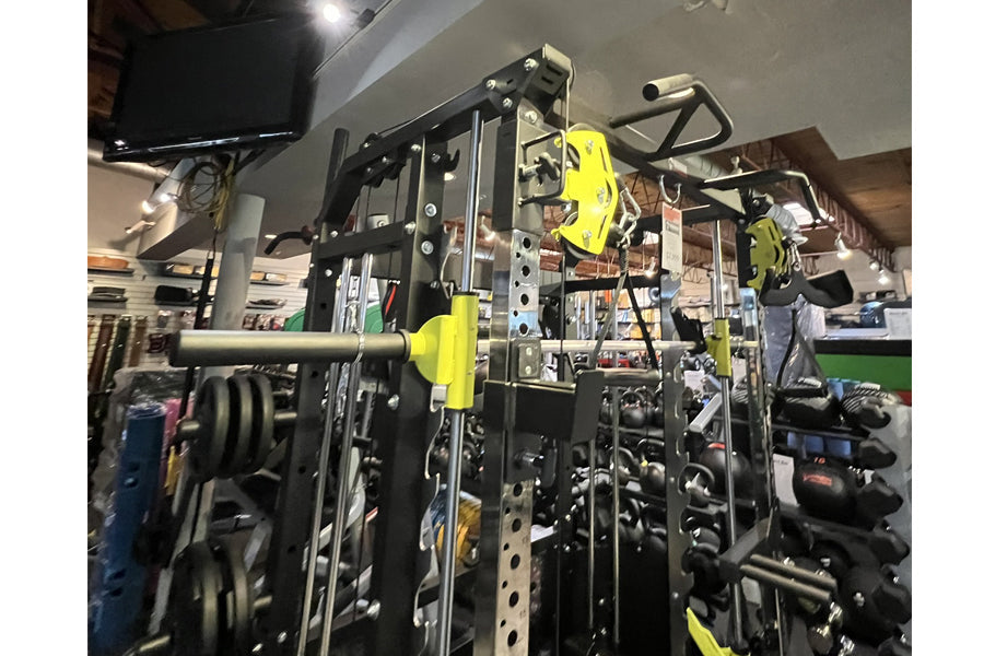 Warrior 701 all-in-one power rack with black and neon yellow functional trainer and cable crossover equipment in gym setting