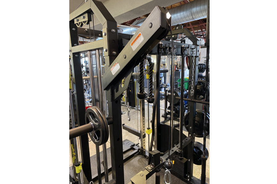 Warrior 701 all-in-one power rack with functional trainer, cable crossover, and Smith cage in black and tan, shown in gym set