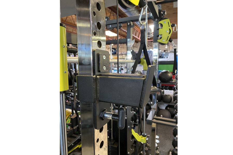 Warrior 701 power rack with cable crossover system, featuring black and yellow metal frame with adjustable pulleys and weight