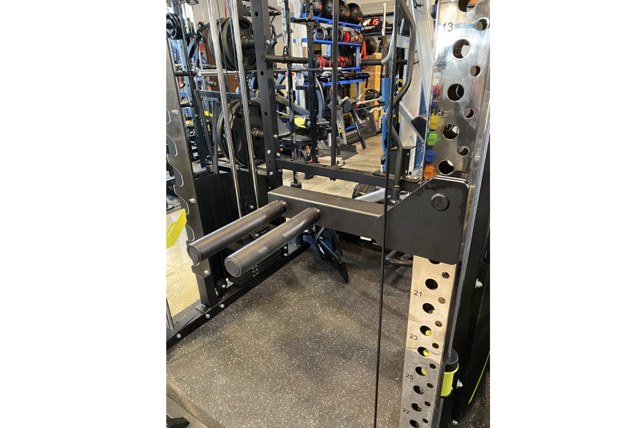 Warrior 701 black power rack with Smith machine cage, cable crossover, and dumbbell rack in gym setting