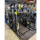 Black and yellow multi-station home gym with integrated smith machine, cable crossover, and functional trainer displayed on w