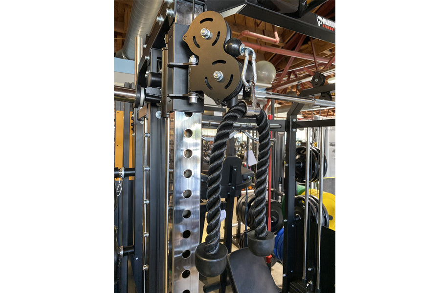 Heavy-duty power rack with dual black twisted cables attached to weight stack, metal frame with hole pattern, and bronze pull