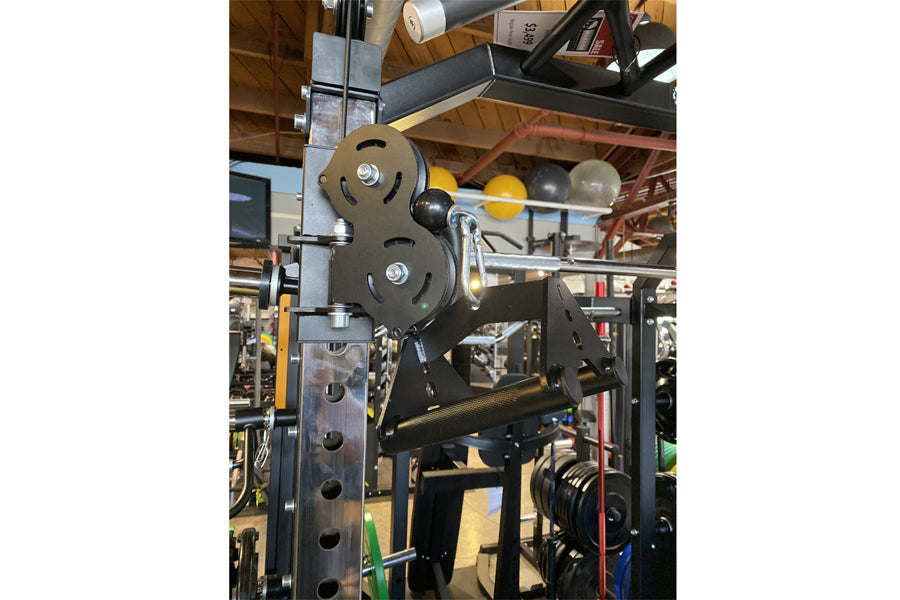 Warrior 701 all-in-one power rack with functional trainer cables, pulley system, and weight plates in workshop setting